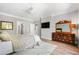 A well-lit bedroom features wood floors, dresser and decorative mirror at 3188 Paces Mill Se Rd, Atlanta, GA 30339