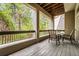 A serene patio surrounded by lush greenery with seating area and wooden railings at 3188 Paces Mill Se Rd, Atlanta, GA 30339