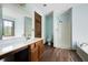 Bathroom featuring a light blue wall, wood cabinets, and a walk-in shower at 1061 Retner Dr, Mableton, GA 30126