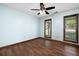 A bedroom with hardwood floors, light blue walls, and natural light from the two windows at 1061 Retner Dr, Mableton, GA 30126