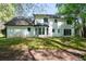 The back of the house overlooks a spacious green lawn, with mature trees at 1061 Retner Dr, Mableton, GA 30126