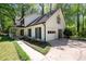 A traditional home features a attached garage and meticulously landscaped front yard at 1061 Retner Dr, Mableton, GA 30126