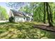 Traditional two-story home with a well-manicured lawn and mature trees for privacy at 1061 Retner Dr, Mableton, GA 30126
