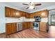 The kitchen has stainless steel appliances, tile backsplash, hardwood floors, and wood cabinets at 1061 Retner Dr, Mableton, GA 30126