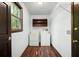 Laundry room with window, washer, dryer, shelving, and hardwood floors at 1061 Retner Dr, Mableton, GA 30126