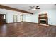 An expansive living room featuring hardwood floors, a fireplace with a mantle, and a wooden beam at 1061 Retner Dr, Mableton, GA 30126