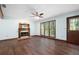 Spacious living room features hardwood floors, ceiling fan, fireplace, and natural light from the large windows at 1061 Retner Dr, Mableton, GA 30126