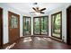 Cozy sunroom with wood-framed windows, hardwood floors, and a view of the trees at 1061 Retner Dr, Mableton, GA 30126