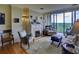 Bright living room with fireplace, hardwood floors, and large windows offering stunning views at 145 15Th Ne St # 1015, Atlanta, GA 30309