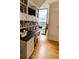 Office with floor-to-ceiling shelves, a granite desktop, a large window with green views, and hardwood floors at 145 15Th Ne St # 1015, Atlanta, GA 30309