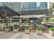 Inviting outdoor dining area with string lights, umbrellas, and comfortable seating at Saints + Council at 145 15Th Ne St # 1015, Atlanta, GA 30309