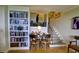 View of a staircase and a bookshelf, next to table and chairs at 145 15Th Ne St # 1015, Atlanta, GA 30309