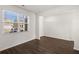 Bright living room with hardwood floors, a large window, and white walls at 1612 Oakbrook Pond Pl, Dacula, GA 30019