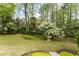 Lush green backyard with mature trees, flowering shrubs, and a serene, natural landscape at 3038 Nancy Creek Nw Rd, Atlanta, GA 30327