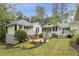 Expansive backyard featuring a brick patio, lush landscaping, and charming architecture at 3038 Nancy Creek Nw Rd, Atlanta, GA 30327