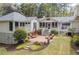 Beautiful backyard with a brick patio, manicured lawn, and lush greenery at 3038 Nancy Creek Nw Rd, Atlanta, GA 30327