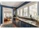 Wet bar area featuring a sink, beverage fridge, and elegant cabinetry at 3038 Nancy Creek Nw Rd, Atlanta, GA 30327