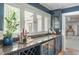 Wet bar area features dark blue cabinets, granite counters and great natural light at 3038 Nancy Creek Nw Rd, Atlanta, GA 30327