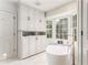 Bright bathroom featuring a soaking tub and a large window with natural light at 3038 Nancy Creek Nw Rd, Atlanta, GA 30327