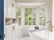 Bright bathroom featuring a soaking tub and a large window with natural light at 3038 Nancy Creek Nw Rd, Atlanta, GA 30327