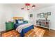 Colorful bedroom with a unique red airplane light fixture, blue bedding and toy storage at 3038 Nancy Creek Nw Rd, Atlanta, GA 30327