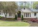 Inviting home exterior featuring a well-manicured lawn and blooming trees at 3038 Nancy Creek Nw Rd, Atlanta, GA 30327