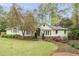 Charming home exterior with manicured lawn and blooming tree providing curb appeal at 3038 Nancy Creek Nw Rd, Atlanta, GA 30327