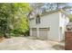 Spacious garage with multiple bays, providing ample parking and storage, surrounded by lush landscaping at 3038 Nancy Creek Nw Rd, Atlanta, GA 30327
