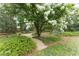 Picturesque garden featuring a gravel path, flowering trees, and lush green foliage at 3038 Nancy Creek Nw Rd, Atlanta, GA 30327