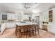 Bright kitchen with a large island, counter seating, skylight, tile floor, and stainless steel appliances at 3038 Nancy Creek Nw Rd, Atlanta, GA 30327