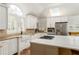 Bright kitchen showcasing a kitchen island with gas cooktop, stainless steel appliances, and tile floor at 3038 Nancy Creek Nw Rd, Atlanta, GA 30327