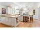 Open kitchen with a large center island, white cabinets, stainless steel appliances, and tile flooring at 3038 Nancy Creek Nw Rd, Atlanta, GA 30327