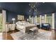 Spacious main bedroom with an elegant chandelier and hardwood floors at 3038 Nancy Creek Nw Rd, Atlanta, GA 30327