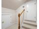 Attic space featuring carpeted steps, a wooden banister, and two interior doors at 4955 Kingsbridge Ct, Powder Springs, GA 30127