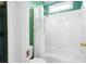 Full bathtub and shower combo with white subway tile and an updated shower head at 4955 Kingsbridge Ct, Powder Springs, GA 30127