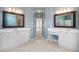 Spacious bathroom featuring double vanity, tile floors, and two large, framed mirrors at 4955 Kingsbridge Ct, Powder Springs, GA 30127