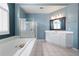 Bathroom featuring a soaking tub, walk-in shower, and vanity at 4955 Kingsbridge Ct, Powder Springs, GA 30127