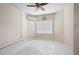 Cozy bedroom featuring neutral walls, a ceiling fan, air conditioning unit, and a window bringing in natural light at 4955 Kingsbridge Ct, Powder Springs, GA 30127