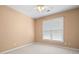 Bedroom with a large window and neutral carpet and wall color at 4955 Kingsbridge Ct, Powder Springs, GA 30127