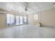 Bright bonus room with neutral walls, ceiling fan, air conditioning, and large windows with natural light at 4955 Kingsbridge Ct, Powder Springs, GA 30127