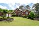Beautiful two-story brick home with a lush front lawn, mature trees, and a well-maintained landscape at 4955 Kingsbridge Ct, Powder Springs, GA 30127