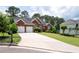 Charming two-story brick home featuring a well-manicured lawn, mature trees, and a long concrete driveway at 4955 Kingsbridge Ct, Powder Springs, GA 30127