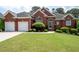 Charming brick home with a well-maintained lawn and a two-car garage at 4955 Kingsbridge Ct, Powder Springs, GA 30127