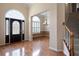 Bright foyer featuring hardwood floors and an elegant staircase at 4955 Kingsbridge Ct, Powder Springs, GA 30127