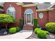 Inviting front entrance with decorative glass door and manicured landscaping at 4955 Kingsbridge Ct, Powder Springs, GA 30127