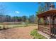 A wooden gazebo offers a serene view of the pond and fountain in this peaceful community space at 4955 Kingsbridge Ct, Powder Springs, GA 30127