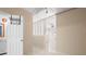 Hallway with white door and storage, leading to a partially open area with neutral walls and modern lighting at 4955 Kingsbridge Ct, Powder Springs, GA 30127