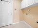 Laundry room featuring tile flooring, utility connections, and neutral wall color at 4955 Kingsbridge Ct, Powder Springs, GA 30127