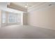 Large main bedroom with tray ceiling, neutral carpet, and natural light at 4955 Kingsbridge Ct, Powder Springs, GA 30127