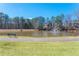 A tranquil pond with a fountain is surrounded by lush greenery and walking paths at 4955 Kingsbridge Ct, Powder Springs, GA 30127